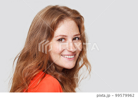 Happy cheerful young woman with red hair. Lady looking at camera with joyful and charming smile. Happy cheerful young woman with red hair. Lady looking at camera with joyful and charming smile. 99579962
