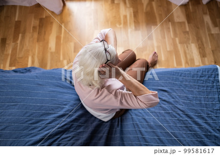 Senior woman suffering from a headache resting at home on sofa Senior woman suffering from a headache resting at home on sofa 99581617
