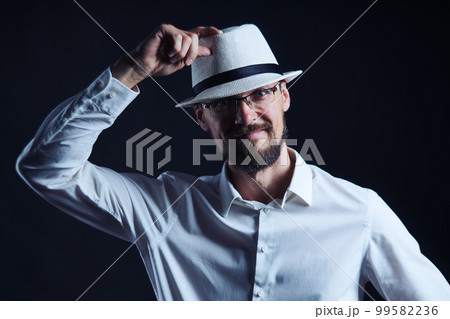 Smiling middle age man in hat lifting his hat Smiling middle age man in hat lifting his hat 99582236