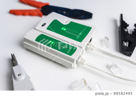 Cat6 RJ45 cable network tester. Twisted pair test tool on the desktop. 99582495