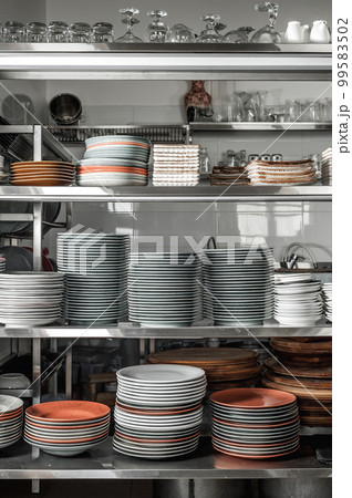 Clean dishes in the restaurant on the shelves 99583502