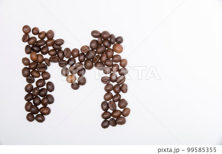 M is a capital letter of the English alphabet made up of natural roasted coffee beans that lie on a white background. M is a capital letter of the English alphabet made up of natural roasted coffee beans that lie on a white background. 99585355