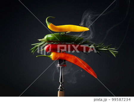 Hot chili peppers with rosemary on black background. Hot chili peppers with rosemary on black background. 99587234