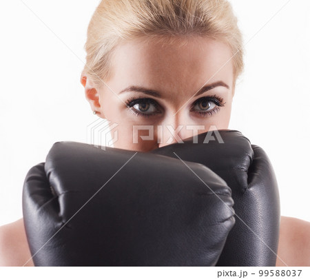 Isolated portrait of athletic Asian woman in black boxing gloves. Slim athletic girl in training clothes looking at camera. Vertical concept photo of sport, boxing, victory, rivalry theme Isolated portrait of athletic Asian woman in black boxing gloves. Slim athletic girl in training clothes looking at camera. Vertical concept photo of sport, boxing, victory, rivalry theme 99588037