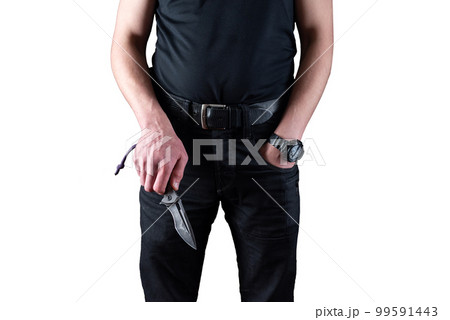 A man in black clothes with a knife in his hands. A man holds a folding knife in his hand. Man and knife on a white background. 99591443