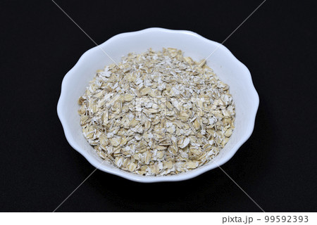 Crushed pearl barley. Pearl flakes. Pearl barley in a plate. 99592393