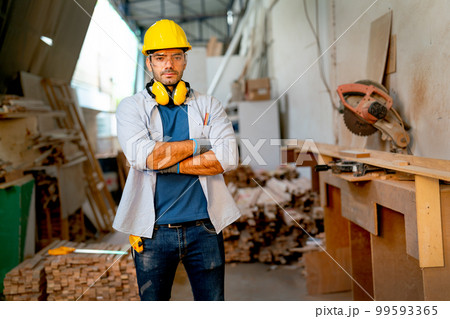 Caucasian carpenter man stand with arm-crossed or confidence action and look at camera Caucasian carpenter man stand with arm-crossed or confidence action and look at camera 99593365