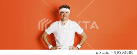 Portrait of confident middle-aged male athlete, wearing sportswear, doing exercises and smiling, workout over orange background Portrait of confident middle-aged male athlete, wearing sportswear, doing exercises and smiling, workout over orange background 99593686