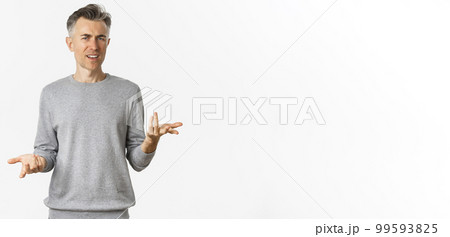 Portrait of confused and disappointed middle-aged man arguing, cant understand something and asking why, standing over white background perplexed Portrait of confused and disappointed middle-aged man arguing, cant understand something and asking why, standing over white background perplexed 99593825