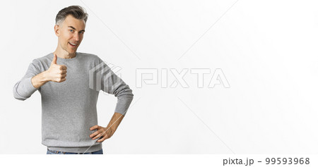 Portrait of proud and happy middle-aged man, smiling pleased and showing thumbs-up, praise something good, standing over white background Portrait of proud and happy middle-aged man, smiling pleased and showing thumbs-up, praise something good, standing over white background 99593968