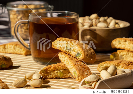 Biscotti Cantuccini Cookie Biscuits with pistachios and lemon peel Shortbread. Cup of tea. Teatime break Healthy eating food. Homemade fresh Italian cookies cantucci stacks and organic pistachios Biscotti Cantuccini Cookie Biscuits with pistachios and lemon peel Shortbread. Cup of tea. Teatime break Healthy eating food. Homemade fresh Italian cookies cantucci stacks and organic pistachios 99596882