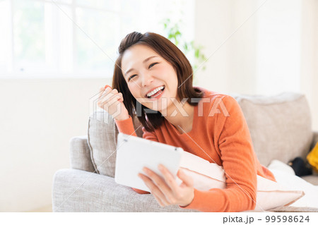タブレットを見る女性　笑顔 99598624