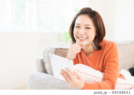 タブレットを見る女性　笑顔 99598641