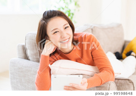 タブレットを見る女性　笑顔 99598648