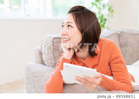 タブレットを見る女性　笑顔 99598651