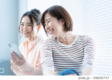スマホを使う二人の女性 スマホを使う二人の女性 99600747