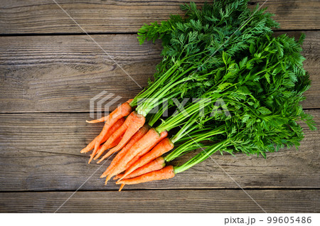 carrot on wooden table background, Fresh and sweet carrots for cooking food fruits and vegetables for health concept, baby carrots bunch and leaf carrot on wooden table background, Fresh and sweet carrots for cooking food fruits and vegetables for health concept, baby carrots bunch and leaf 99605486