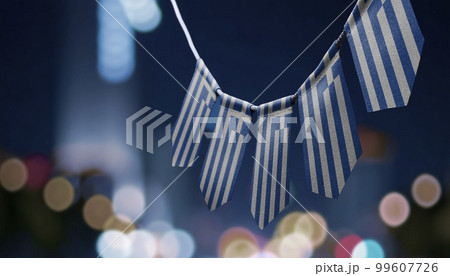 A garland of Greece national flags on an abstract blurred background A garland of Greece national flags on an abstract blurred background 99607726