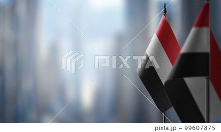 Small flags of the Yemen on an abstract blurry background 99607875