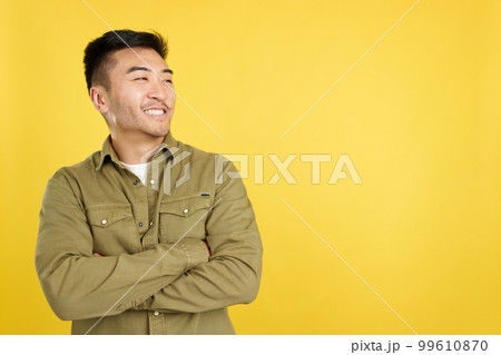 Chinese man smiling while looking to the side Chinese man smiling while looking to the side 99610870