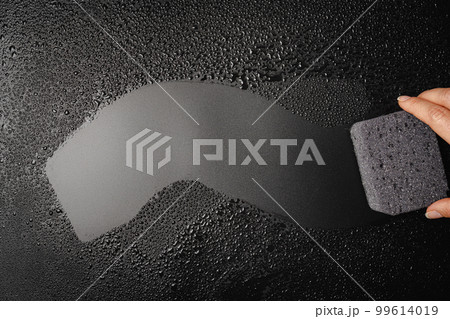 Sponge placed on wet black background Sponge placed on wet black background 99614019