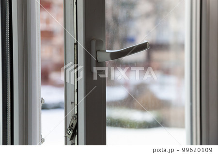 Open white plastic pvc window in winter on a cloudy day. 99620109