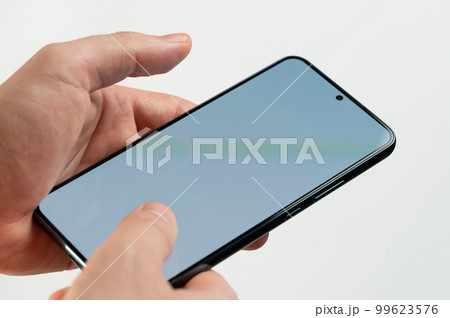 Smartphone  in hands close up view 99623576