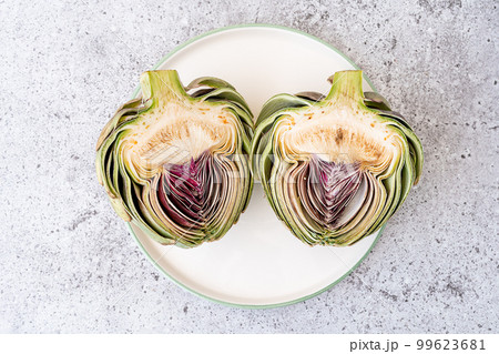 Top view Sliced artichoke on plate on table. Healthy food vegetables. 99623681