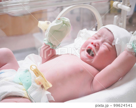 new born baby infant sleep in the incubator at hospital 99624541