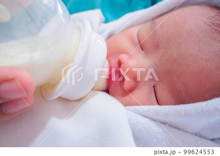 Mother feeding newborn baby from the bottle Mother feeding newborn baby from the bottle 99624553