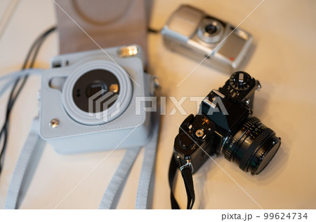 three film old professional cameras with lenses. three film old professional cameras with lenses. 99624734