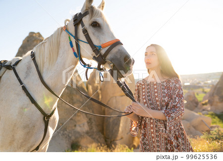 beautiful girl outdoors in the mountains with her faithful horse. beautiful girl outdoors in the mountains with her faithful horse. 99625536