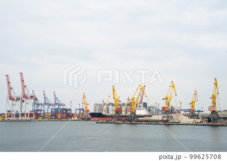 seaport where large cranes are loaded containers on cargo ships seaport where large cranes are loaded containers on cargo ships 99625708