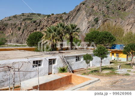 a poor house in a village in the middle of mountains between palm trees in Turkey. a poor house in a village in the middle of mountains between palm trees in Turkey. 99626966