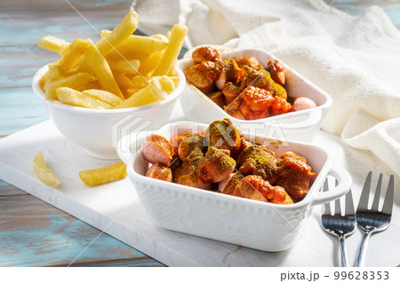 German homemade currywurst with fried pork sausage and curry ketchup 99628353