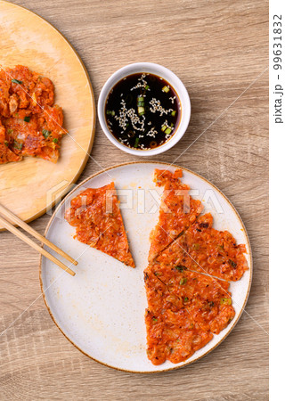 Korean Kimchi pancake (Kimchi jeon or kimchi buchimgae) on plate eating with soy dipping sauce Korean Kimchi pancake (Kimchi jeon or kimchi buchimgae) on plate eating with soy dipping sauce 99631832
