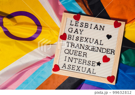 LGBTQIA description frame on Rainbow LGBTQIA flag made from silk material. LESBIAN, GAY, BISEXUAL, TRANSGENDER, QUEER, INTERSEX, ASEXUAL Symbol of LGBTQ pride month. Equal rights. Peace and freedom LGBTQIA description frame on Rainbow LGBTQIA flag made from silk material. LESBIAN, GAY, BISEXUAL, TRANSGENDER, QUEER, INTERSEX, ASEXUAL Symbol of LGBTQ pride month. Equal rights. Peace and freedom 99632812