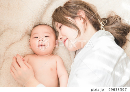 布団の上でリラックスする赤ちゃんと産後のママ(親子・出産・母子・産後・産褥期) 布団の上でリラックスする赤ちゃんと産後のママ(親子・出産・母子・産後・産褥期) 99633597