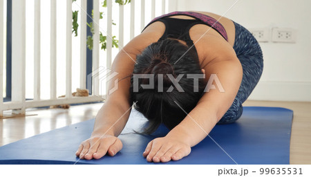 Women yoga meditation stretching back, arm meditate home fitness on floor. Happiness Young women doing yoga Balasana child pose. Wellness woman in sportswear meditate relaxation stretch health care Women yoga meditation stretching back, arm meditate home fitness on floor. Happiness Young women doing yoga Balasana child pose. Wellness woman in sportswear meditate relaxation stretch health care 99635531