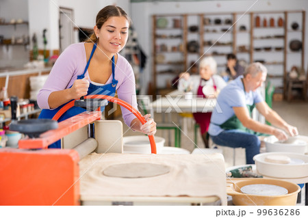 girl is working with machine clay press roller 99636286