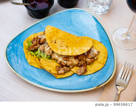 Mexican tacos with fried chicken, guacamole and salsa Mexican tacos with fried chicken, guacamole and salsa 99636617