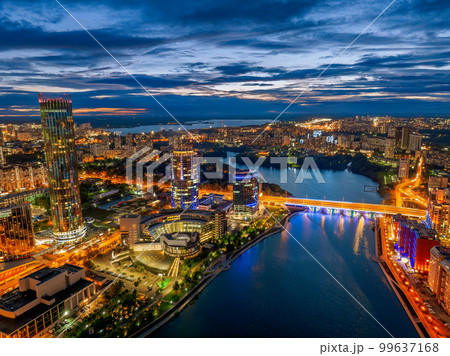 Yekaterinburg city and pond aerial panoramic view at summer or early autumn night. Night city in the early autumn or summer. Yekaterinburg city and pond aerial panoramic view at summer or early autumn night. Night city in the early autumn or summer. 99637168