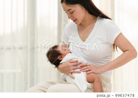 mother breastfeeding newborm baby near the window mother breastfeeding newborm baby near the window 99637478
