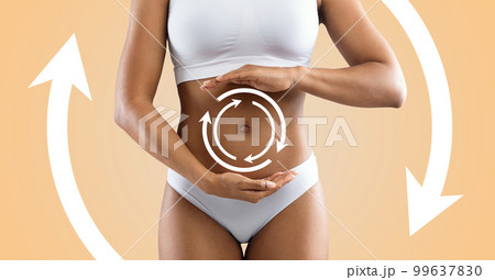 Young slim black woman in white lingerie with abstract lines and arrows doing belly massage 99637830