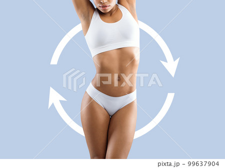 Young slim african american woman in white lingerie enjoys weight loss result with abstract arrows around 99637904