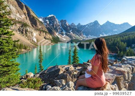 Young girl enjoying Moraine Lake beautiful scenery. Banff National Park nature landscape. Canadian Rockies summer time. Alberta, Canada. 99639527