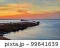 Old abandoned damaged fishing boat laying on the stone pier 99641639