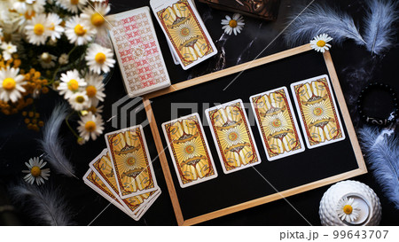 Woman forecasting with Tarot cards, Fortune telling esoteric tarot predictions Woman forecasting with Tarot cards, Fortune telling esoteric tarot predictions 99643707