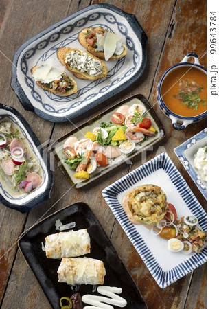 selection of many different tapas on rustic wood table 99643784