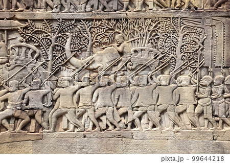 Wall carving with depicting troops, soldiers and military leaders on elephants in Prasat Bayon Temple, in famous Angkor Wat complex, khmer culture, Siem Reap, Cambodia Wall carving with depicting troops, soldiers and military leaders on elephants in Prasat Bayon Temple, in famous Angkor Wat complex, khmer culture, Siem Reap, Cambodia 99644218